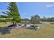 Well-manicured backyard featuring a pond and lush landscaping at 1647 Emerald Dunes Dr, Sun City Center, FL 33573