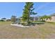 Landscaped backyard with mature trees, providing a serene outdoor space at 1647 Emerald Dunes Dr, Sun City Center, FL 33573