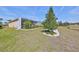 Backyard featuring a screened-in patio and lush landscaping at 1647 Emerald Dunes Dr, Sun City Center, FL 33573