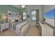 Bright bedroom with beach-themed decor, modern furniture, ceiling fan, and natural light at 1647 Emerald Dunes Dr, Sun City Center, FL 33573