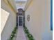 Covered entry with a well-maintained walkway and accent lighting at 1647 Emerald Dunes Dr, Sun City Center, FL 33573