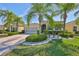 Charming single-story home features tropical landscaping and a patterned driveway at 1647 Emerald Dunes Dr, Sun City Center, FL 33573