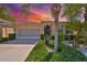 Charming single-story home features tropical landscaping and a patterned driveway at 1647 Emerald Dunes Dr, Sun City Center, FL 33573