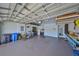 Spacious garage with high ceilings, storage racks, and ample space for vehicles and storage at 1647 Emerald Dunes Dr, Sun City Center, FL 33573