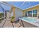 Covered outdoor hot tub in the sun with a roll-down privacy screen and tile flooring at 1647 Emerald Dunes Dr, Sun City Center, FL 33573