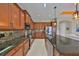 Kitchen with sleek stainless steel appliances, granite countertops, and an island sink with breakfast bar at 1647 Emerald Dunes Dr, Sun City Center, FL 33573