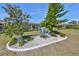 Close up of backyard landscaping with white gravel bed around a tree and agave at 1647 Emerald Dunes Dr, Sun City Center, FL 33573