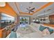 Bright living room with large white sectional, sliding glass doors to patio and a modern entertainment center at 1647 Emerald Dunes Dr, Sun City Center, FL 33573