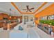 Open-concept living room featuring a large white sectional, a ceiling fan and a kitchen bar with seating at 1647 Emerald Dunes Dr, Sun City Center, FL 33573