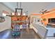 Open floor plan with a dining area flowing into the kitchen and living room with vibrant orange accent wall at 1647 Emerald Dunes Dr, Sun City Center, FL 33573