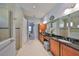 This is a view of the main bathroom that features double sinks, granite countertops, and a walk-in shower at 1647 Emerald Dunes Dr, Sun City Center, FL 33573