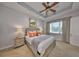The main bedroom features a tray ceiling, ceiling fan, and a large window for natural light at 1647 Emerald Dunes Dr, Sun City Center, FL 33573