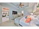 This is a view of the main bedroom that includes a tray ceiling, a ceiling fan, and access to other rooms at 1647 Emerald Dunes Dr, Sun City Center, FL 33573