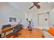 Bright office with hardwood floors, ceiling fan, ample workspace, and comfortable seating area at 1647 Emerald Dunes Dr, Sun City Center, FL 33573