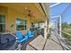 Outdoor space with ceiling fans, kitchen, blue seating, greenery, and tile flooring at 1647 Emerald Dunes Dr, Sun City Center, FL 33573