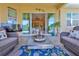 Stylish covered patio featuring comfortable seating and a TV, perfect for outdoor relaxation at 1647 Emerald Dunes Dr, Sun City Center, FL 33573