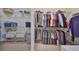 Well-organized walk-in closet with ample shelving and hanging space for clothes and personal items at 1647 Emerald Dunes Dr, Sun City Center, FL 33573