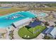 The clear lagoon, sandy beach, waterpark, lounge chairs, and community gathering spaces offer endless entertainment at 16646 Maude Dr, Wimauma, FL 33598