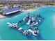 Enjoy an aerial view of the community's inflatable waterpark and the large crystal blue lagoon at 16646 Maude Dr, Wimauma, FL 33598