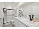 Bright bathroom featuring a walk-in shower with black trim and double sink vanity at 16646 Maude Dr, Wimauma, FL 33598
