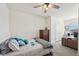 Comfortable bedroom featuring a bed with blue accent pillows and a wooden dresser at 16646 Maude Dr, Wimauma, FL 33598