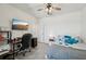 Well-lit bedroom with a dedicated workspace, a comfortable bed, and mounted television at 16646 Maude Dr, Wimauma, FL 33598