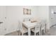 Elegant dining room featuring a white table, upholstered chairs, and natural light at 16646 Maude Dr, Wimauma, FL 33598