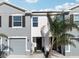 Charming townhome featuring a one-car garage, gray and white stucco, and well-maintained landscaping at 16646 Maude Dr, Wimauma, FL 33598