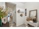 Inviting hallway with neutral tones, leading to the living area and decorated with tasteful wall decor at 16646 Maude Dr, Wimauma, FL 33598