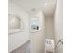 Upstairs hallway with plush gray carpeting and a decorative mirror at 16646 Maude Dr, Wimauma, FL 33598