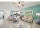 Open concept living area with a modern kitchen, comfortable seating, and stylish coastal accents at 16646 Maude Dr, Wimauma, FL 33598