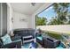 Relaxing outdoor patio featuring a hot tub and cushioned seating area at 16646 Maude Dr, Wimauma, FL 33598