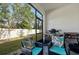 This screened patio features comfortable seating and outdoor cooking equipment at 16646 Maude Dr, Wimauma, FL 33598