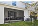 A screened-in patio features comfortable seating and a ceiling fan at 16646 Maude Dr, Wimauma, FL 33598
