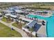 Expansive community pool area featuring lounge seating, covered pavilions, and ample space for residents to relax and enjoy the outdoors at 16646 Maude Dr, Wimauma, FL 33598