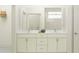 Elegant bathroom featuring a double vanity with marble countertop and a spacious shower area at 18453 Serene Lake Loop, Lutz, FL 33548