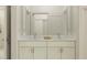 Modern bathroom featuring a double sink vanity, marble countertop, and a well-lit shower with white subway tile at 18453 Serene Lake Loop, Lutz, FL 33548