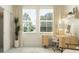 Bright home office with a modern computer desk, lots of natural light from large windows, and a calming decor at 18453 Serene Lake Loop, Lutz, FL 33548