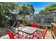 Relaxing outdoor seating area on a wooden deck, offering views of the backyard and pool area at 18846 Tracer Dr, Lutz, FL 33549