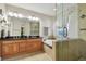 Bathroom with double sinks, separate shower, tub, dark granite countertop and tiled floor at 18846 Tracer Dr, Lutz, FL 33549