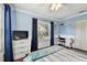 Comfortable bedroom features natural light, cool blue walls, and plenty of space for relaxing at 18846 Tracer Dr, Lutz, FL 33549