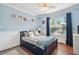 Comfortable bedroom features natural light, cool blue walls, and plenty of space for relaxing at 18846 Tracer Dr, Lutz, FL 33549