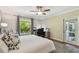 Bedroom with a large window, ceiling fan, wood floor, work space and neutral wall colors at 18846 Tracer Dr, Lutz, FL 33549