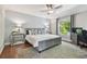 Bedroom with a large window, ceiling fan, wood floor, work space and neutral wall colors at 18846 Tracer Dr, Lutz, FL 33549