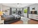 Bedroom with hardwood floors, bright lighting, and a workstation at 18846 Tracer Dr, Lutz, FL 33549