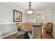 Dining room features hardwood floors, chandelier, seating for four, and neutral wall colors at 18846 Tracer Dr, Lutz, FL 33549