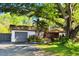 Charming home with a well-maintained front yard, mature trees, and driveway at 18846 Tracer Dr, Lutz, FL 33549