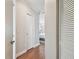 Inviting hallway featuring hardwood floors, leading to a bedroom with neutral wall colors at 18846 Tracer Dr, Lutz, FL 33549