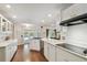 Modern kitchen with white cabinetry, quartz countertops, stainless steel appliances, and open layout at 18846 Tracer Dr, Lutz, FL 33549