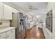 Spacious kitchen with stainless steel refrigerator, white cabinets, hardwood floors, and ample counter space at 18846 Tracer Dr, Lutz, FL 33549